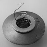 An image of a threaded insert with a broken thread