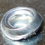 The scratched head of a nut insert after installation